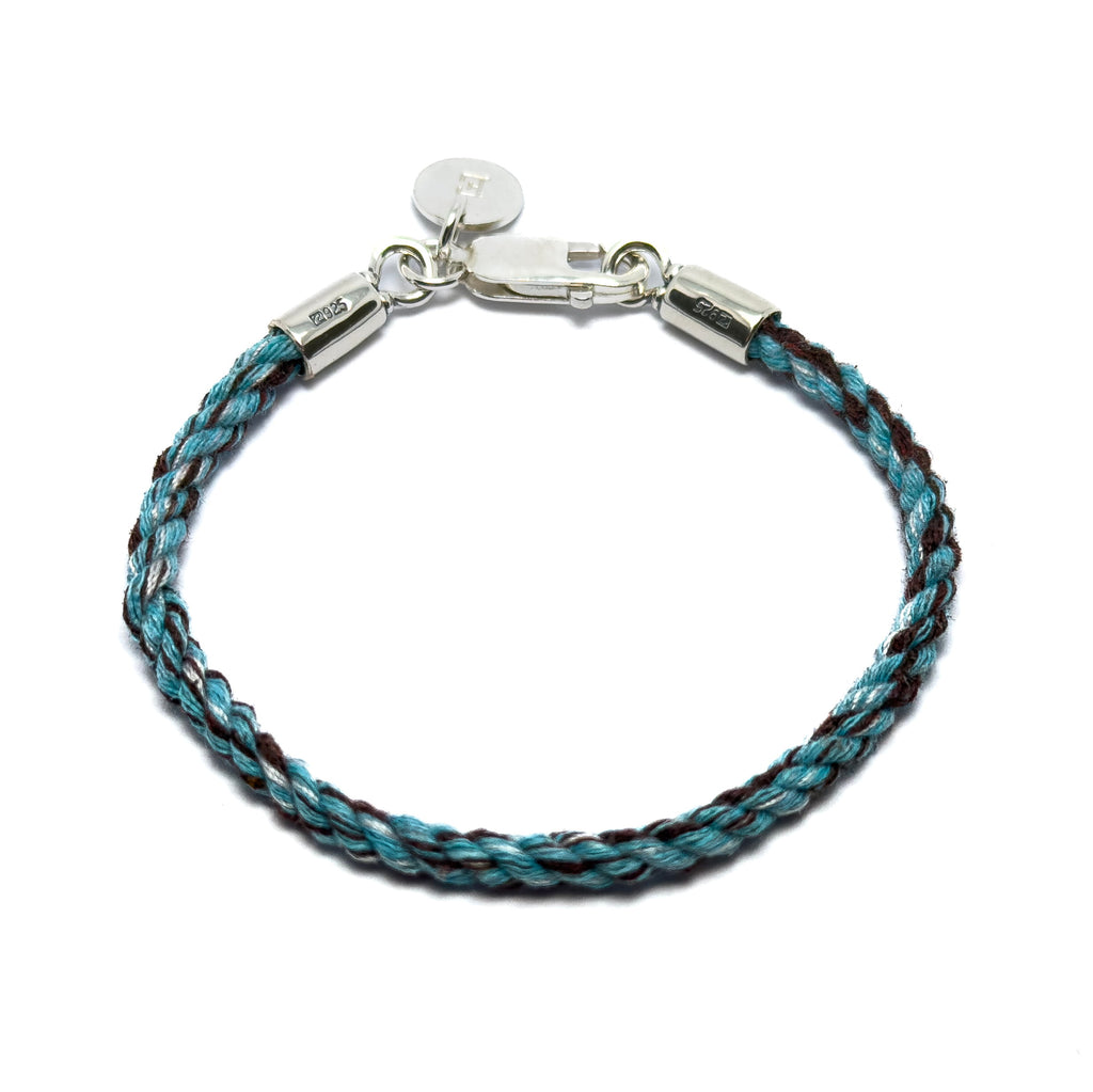 Bracelet made from pets collar with braided blue and brown cord and silver clasp on a white background