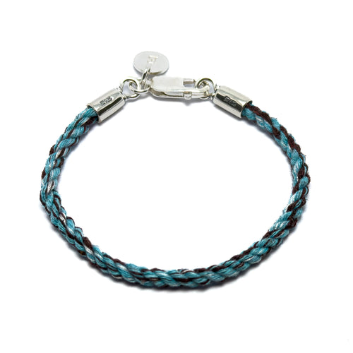 Bracelet made from pets collar with braided blue and brown cord and silver clasp on a white background